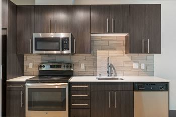 a kitchen with a stove top oven next to a sink